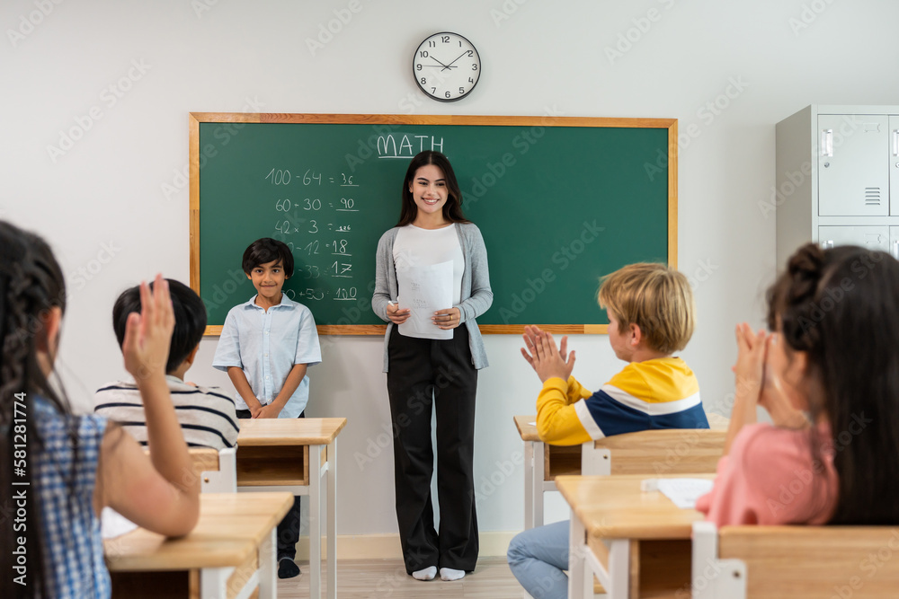 Group of student learn with teacher in classroom at elementary school. 