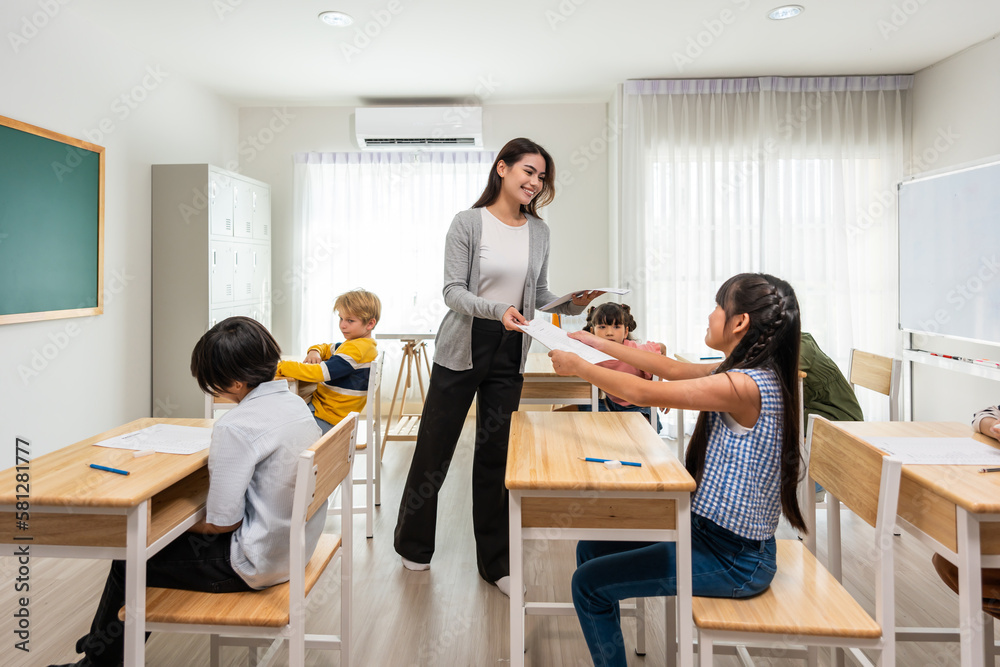 Group of student learn with teacher in classroom at elementary school. 