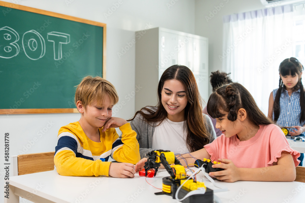 Caucasian woman teacher teaching a lesson to kids at elementary school.