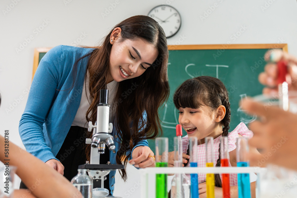 Caucasian woman teacher teaching a lesson to kids at elementary school. 