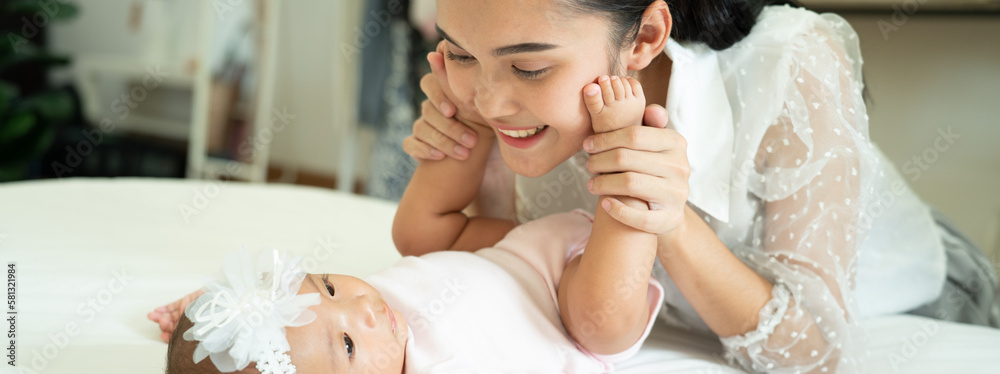 Asian Baby feet in mothers hands that mean symblo of love. Mom and her Baby Child. Happy Family con