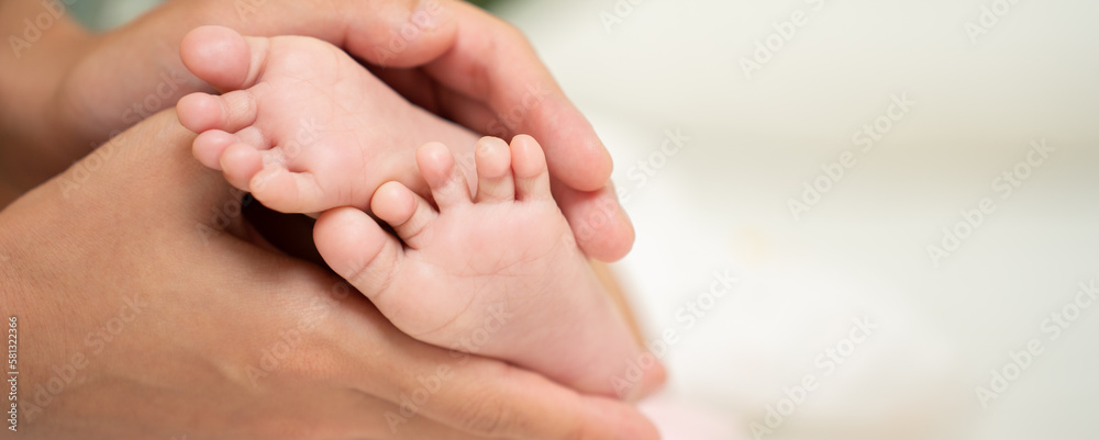 Asian Baby feet in mothers hands that mean symblo of love. Mom and her Baby Child. Happy Family con