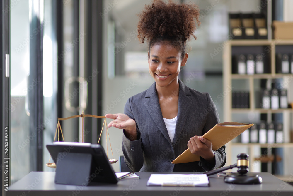 Female lawyer working on a desk in a law office.