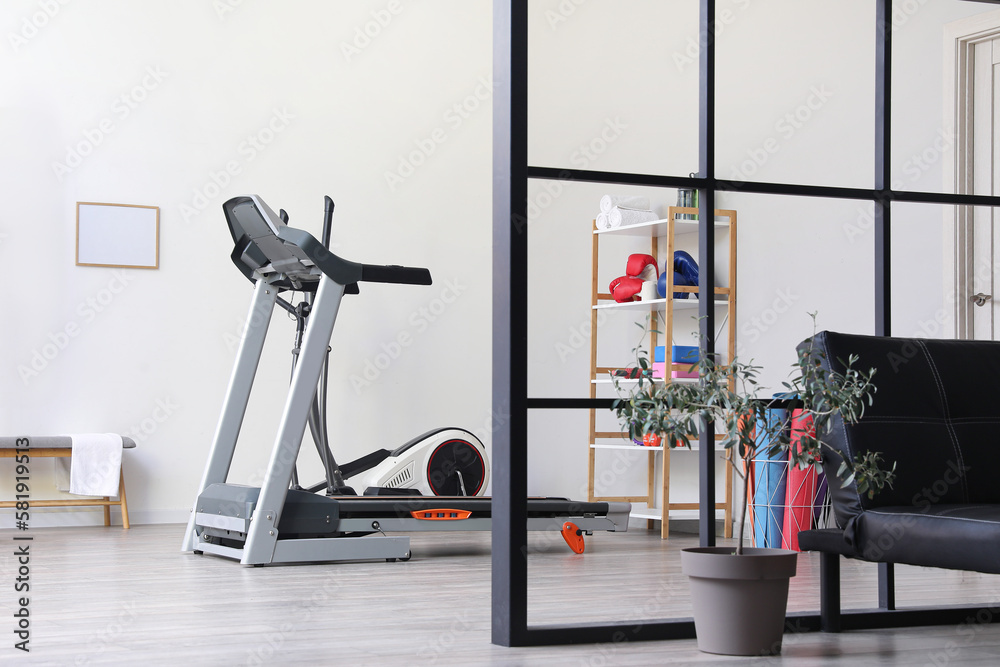 Interior of gym with modern treadmill and sport equipment