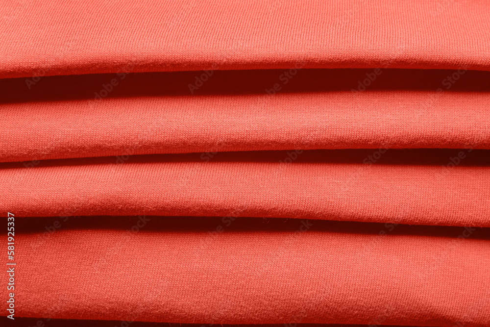 Closeup view of coral folded fabric texture as background