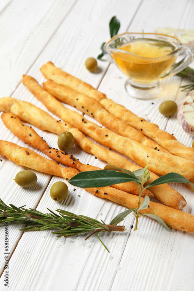 Tasty Italian Grissini on light wooden background