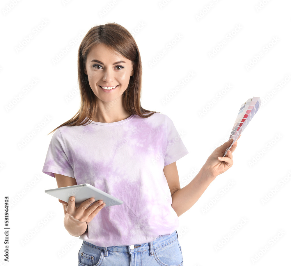 Beautiful woman with paint color palettes and tablet computer on white background