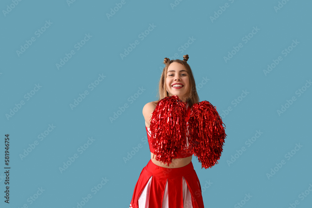 Beautiful cheerleader on blue background