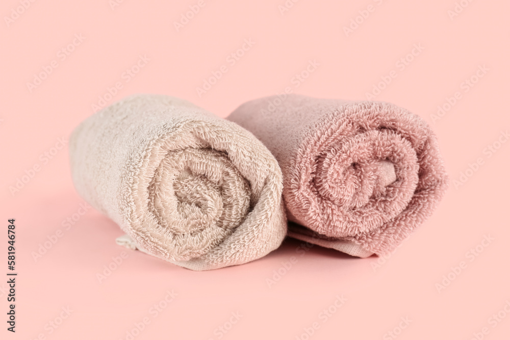 Clean soft towels on pink background