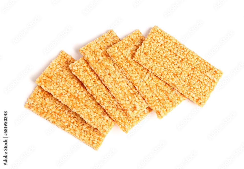 Tasty sesame kozinaki bars on white background