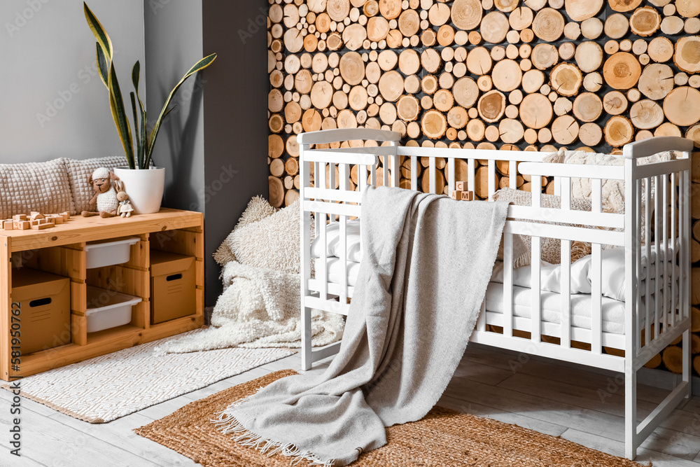 Interior of childrens bedroom with baby crib and shelving unit