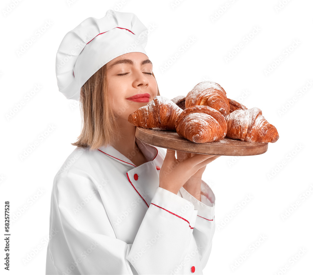 Female baker with board of tasty croissants on white background