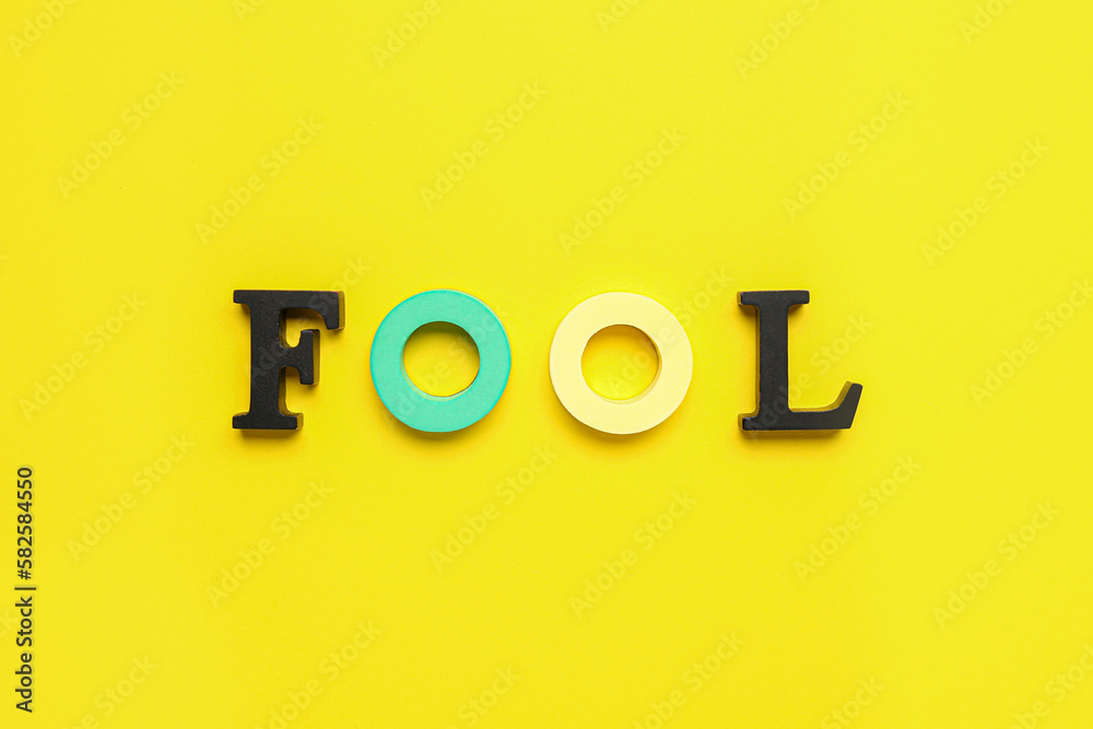 Word FOOL on yellow background