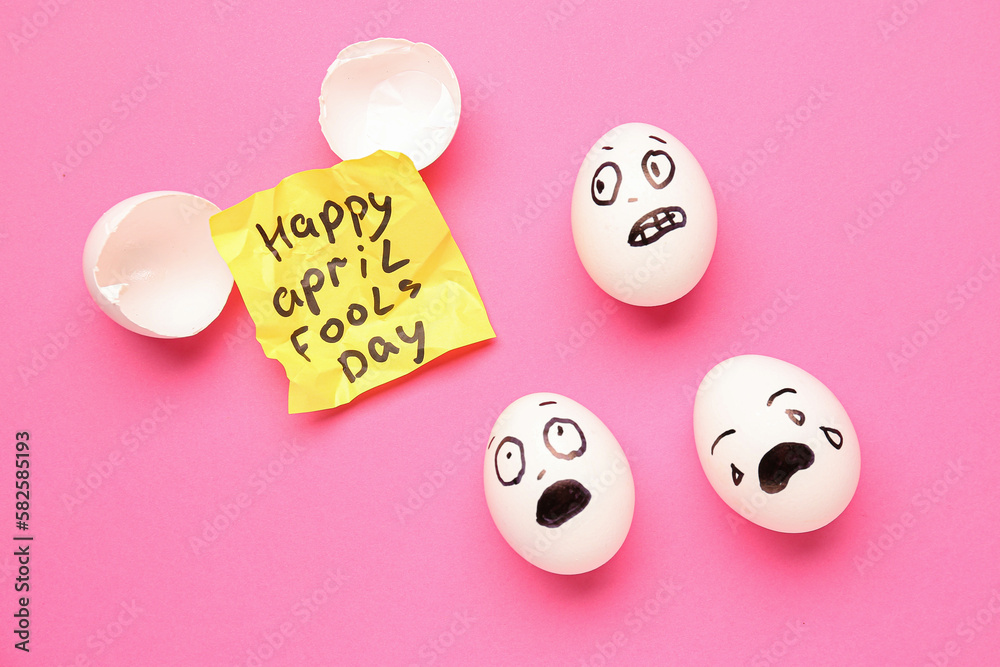 Paper with text HAPPY APRIL FOOLS DAY and eggs on pink background