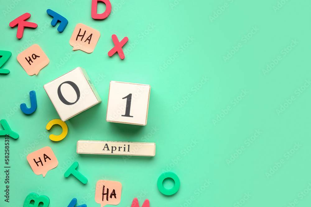 Date of April Fools Day with letters and sticky papers on color background