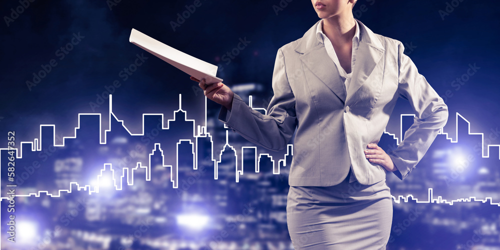 Woman architect or engineer presenting construction concept and holding documents in hand