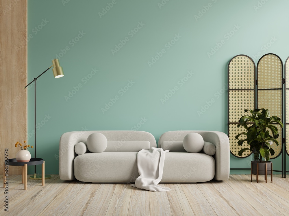 Wall mockup in green color with gray sofa and decor in living room.