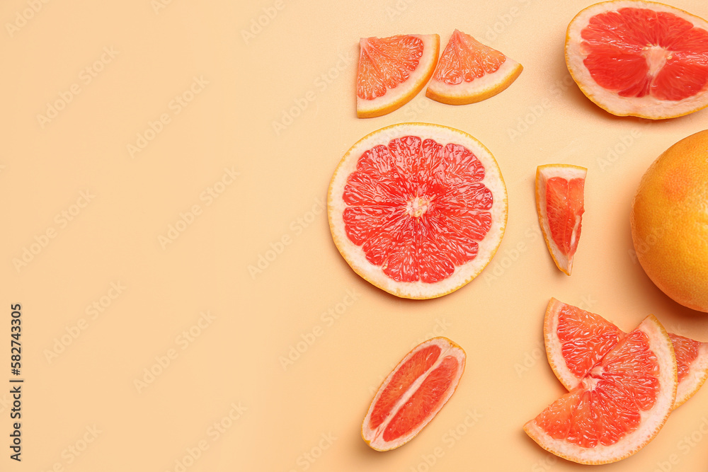 Composition with pieces of ripe grapefruit on color background