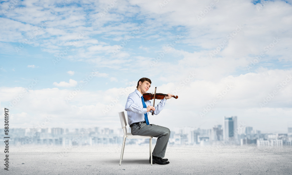 young businessman playing violin