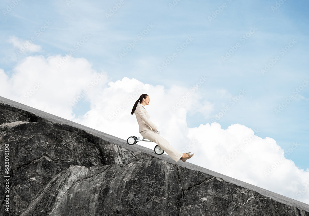 Beautiful happy woman riding downhill