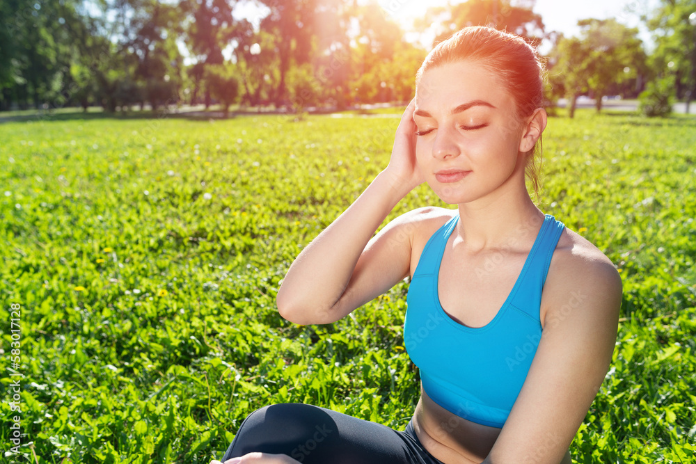 Smiling woman training outdoor at sunny day