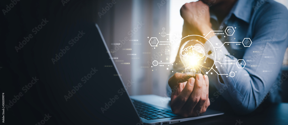 Man working and holding light bulb on the desk, Idea, innovation, and inspiration concept, creativit