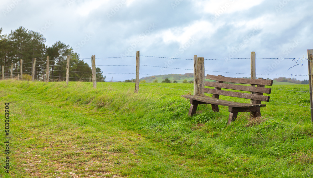 A chair on the historical pilgrims trail with german countryside landscape In Lampertstal und Alendo