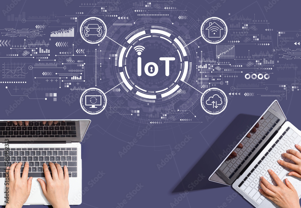 IoT theme with people working together with laptop computers