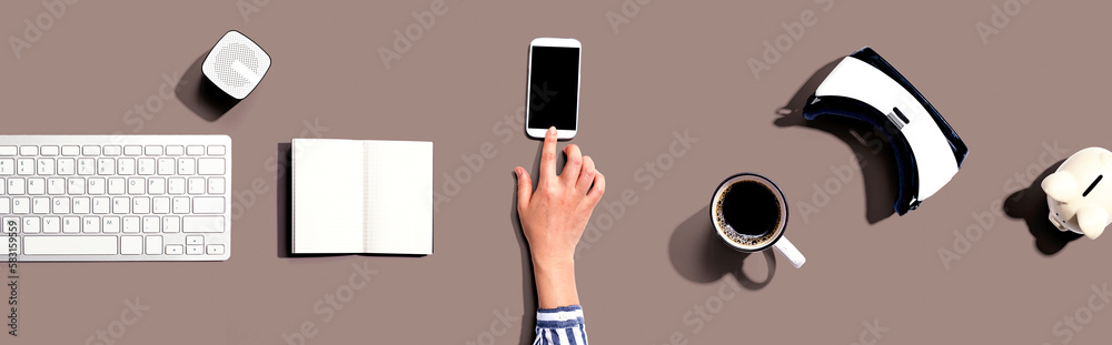 Person using a smartphone with a VR and a computer keyboard