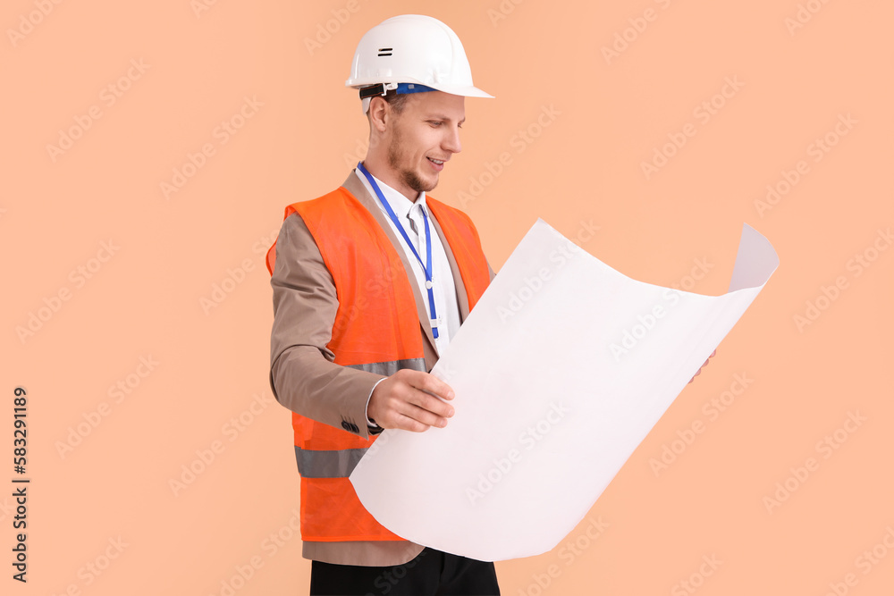 Male architect with drawing on beige background