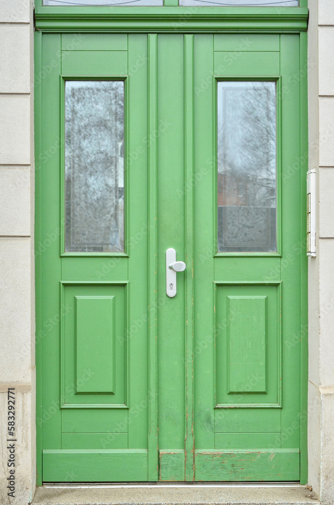 View of old building with green wooden door