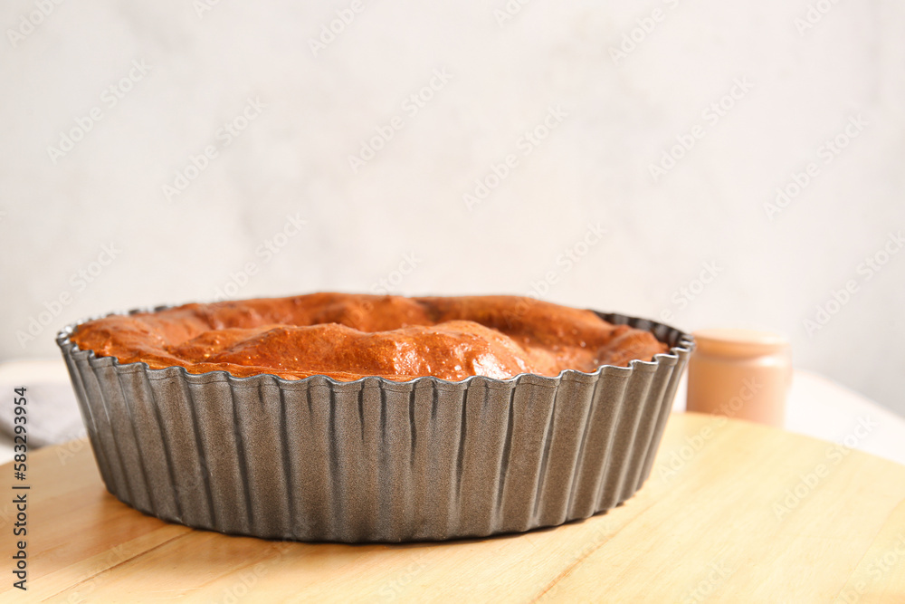 Board with delicious meat pie in baking form, closeup