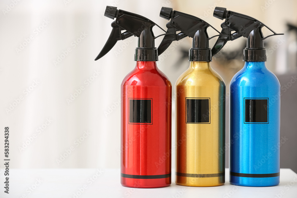 Hair sprays on table in beauty salon, closeup