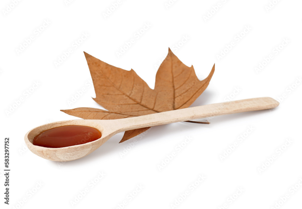 Spoon of tasty maple syrup and leaf on white background