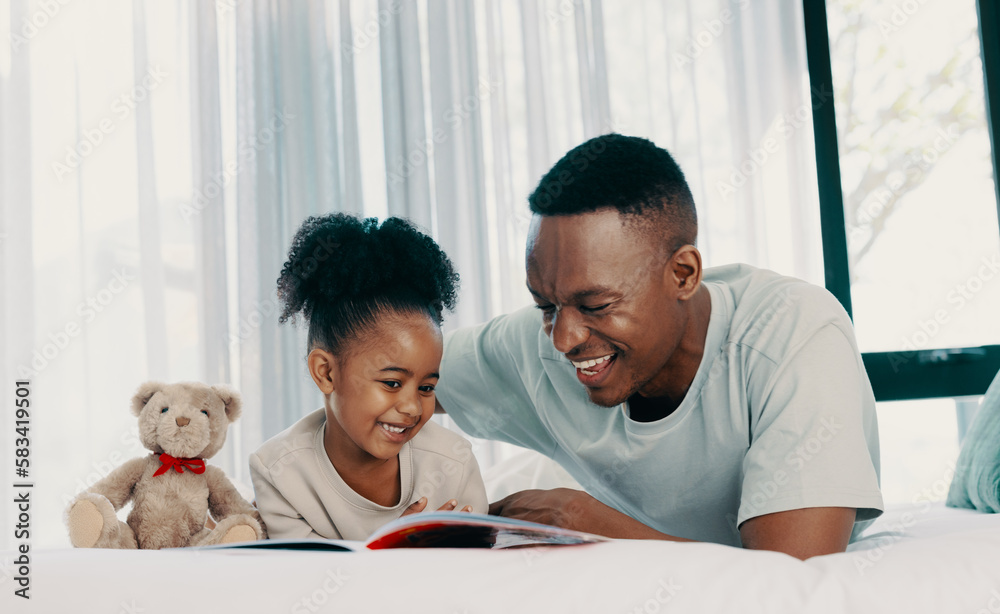 Father reading a daytime story with his daughter at home