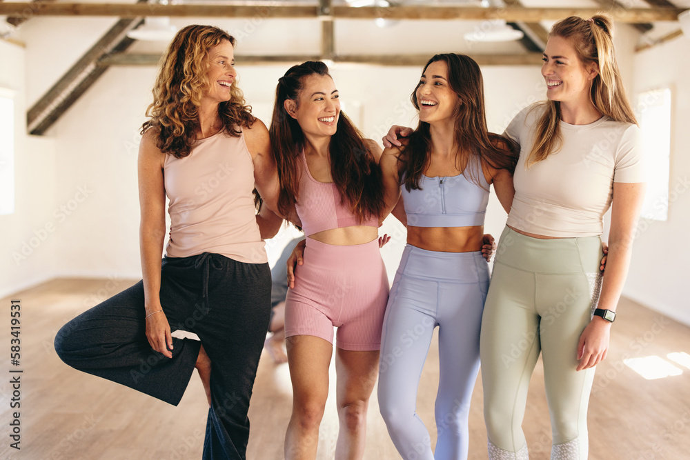 Group of women standing together in a yoga studio