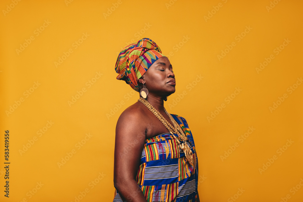 Mature woman wearing an African traditional atttire in a studio