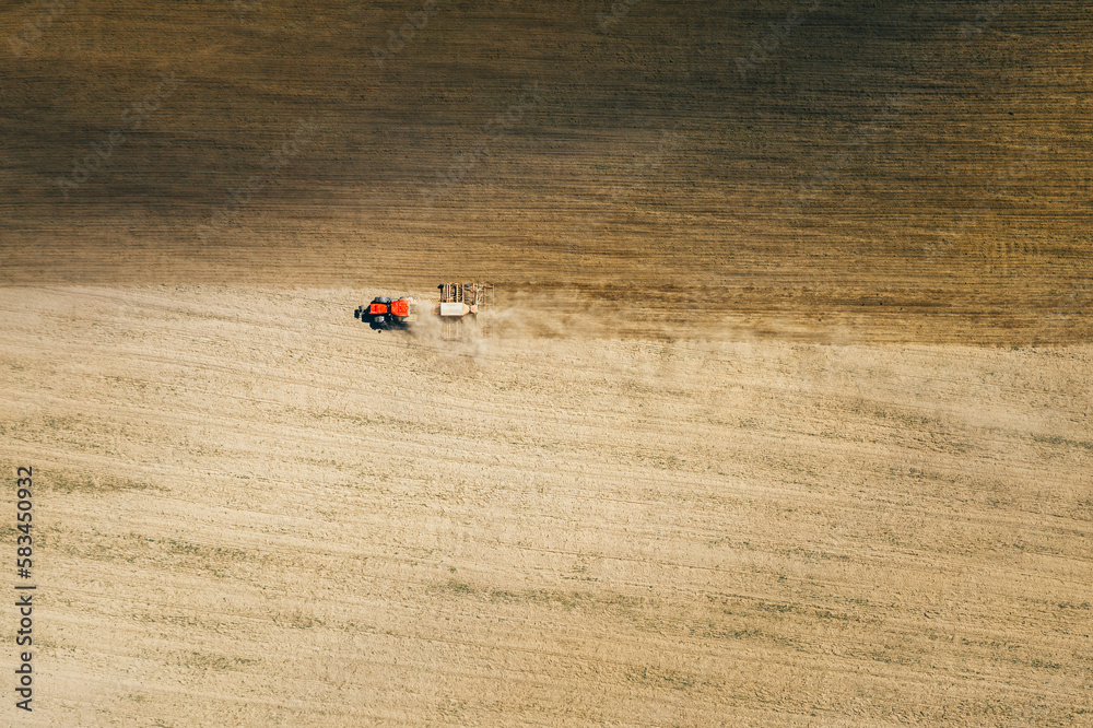 Aerial View. Tractor With Seed Drill Machine Sowing The Seeds For Crops In Spring Season. Beginning 