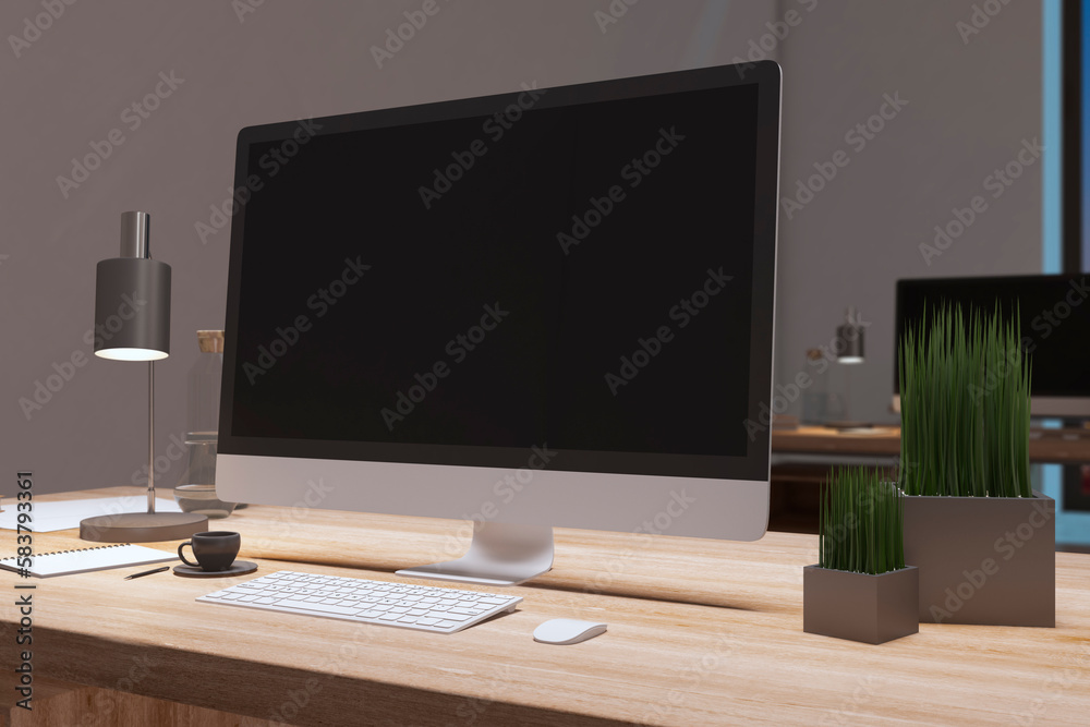 Close up of designer office desktop with empty black computer monitor, decorative items and supplies