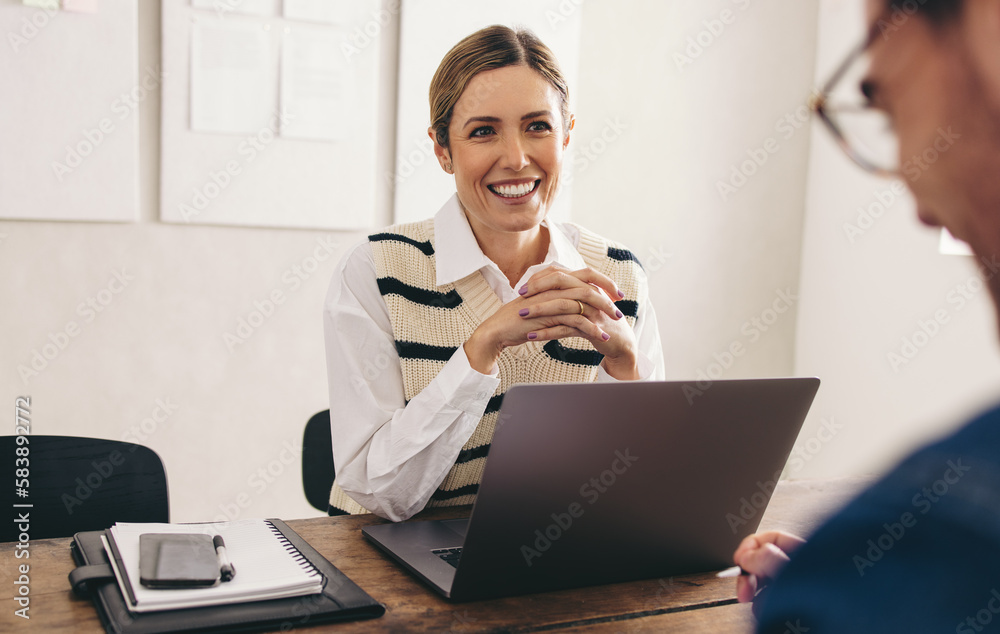 Female hiring manager interviewing a job candidate in her office