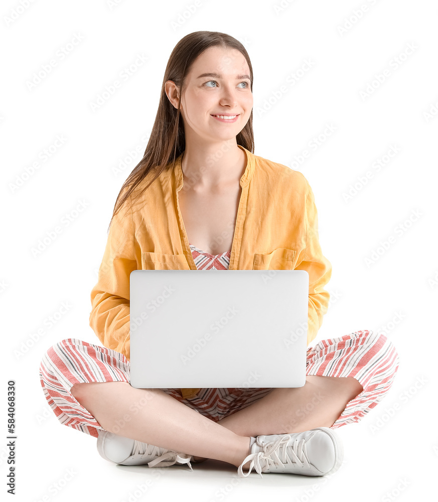 Pretty young woman with laptop sitting against white background