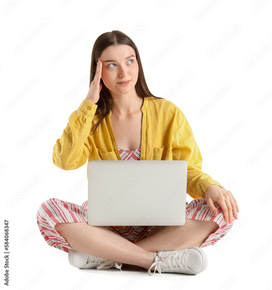 Pretty young woman with laptop sitting against white background