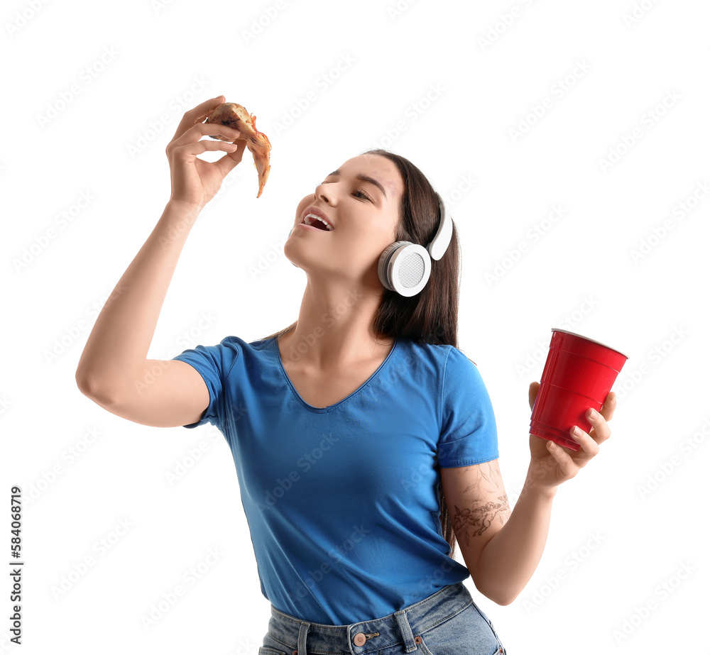 Young woman in headphones with tasty pizza and cup on white background