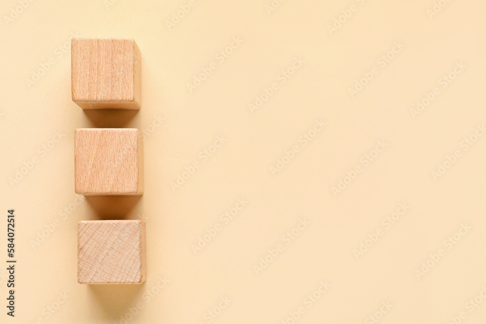 Wooden cubes with check marks on beige background