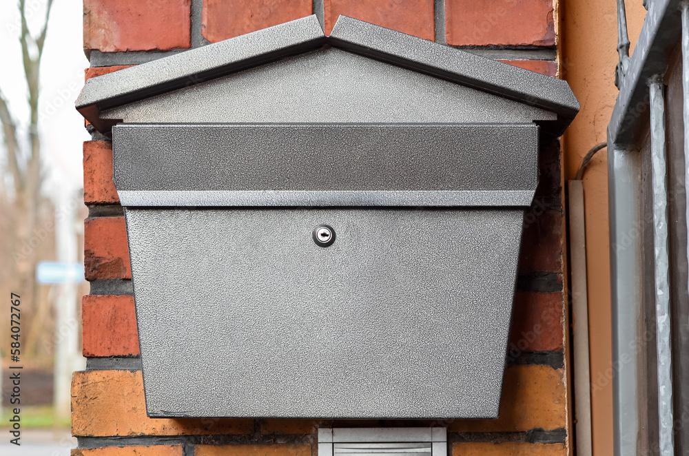 View of mailbox on brick building wall, closeup