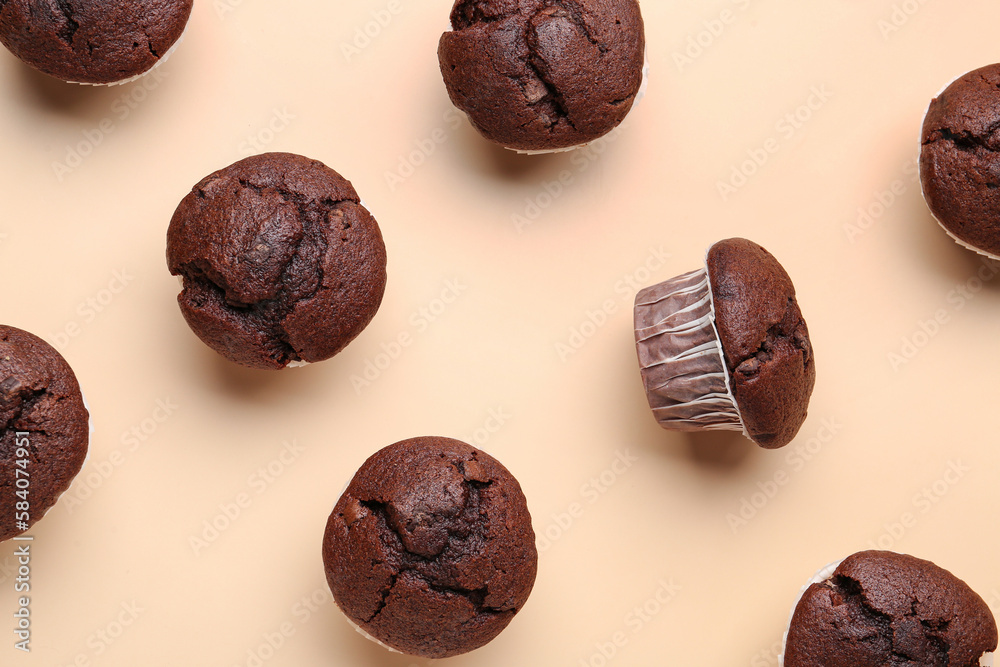 Tasty chocolate cupcakes on beige background