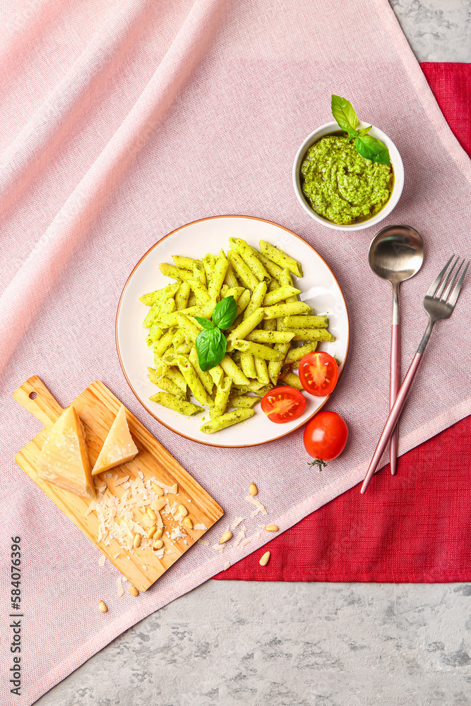 Plate with pesto pasta on table