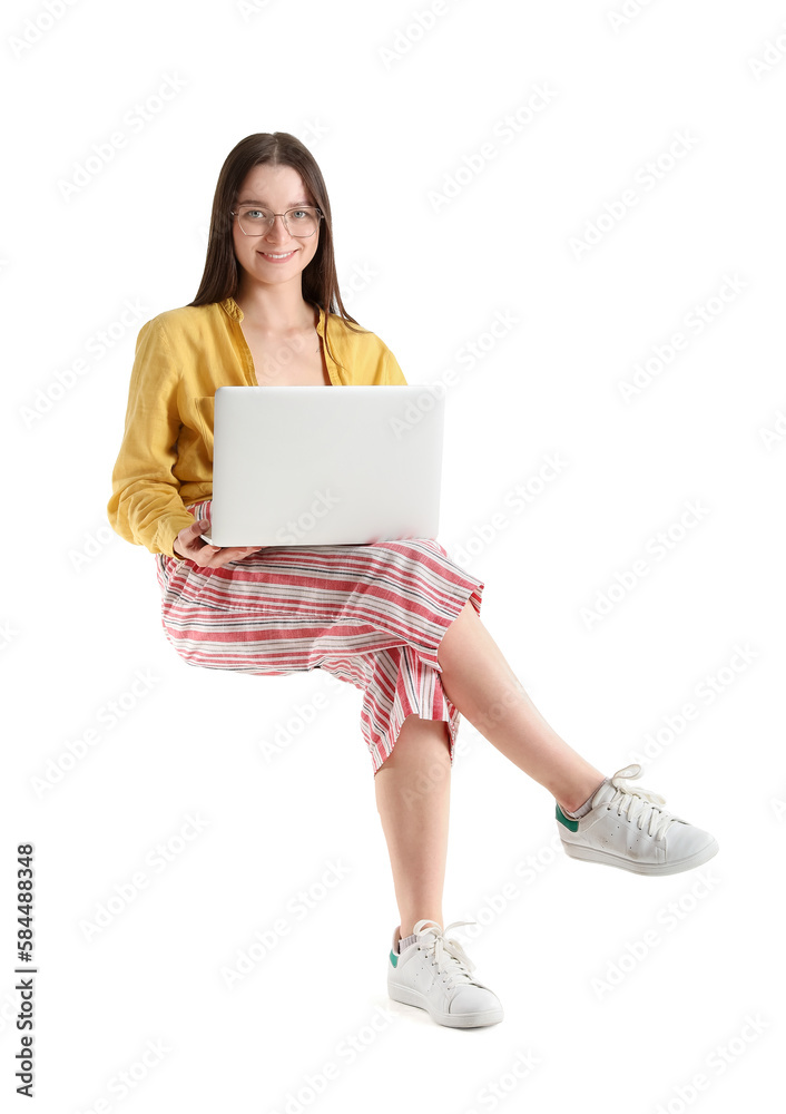 Pretty young woman with laptop sitting on chair against white background