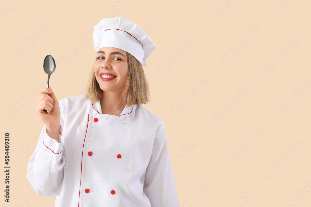 Female chef with tablespoon on beige background