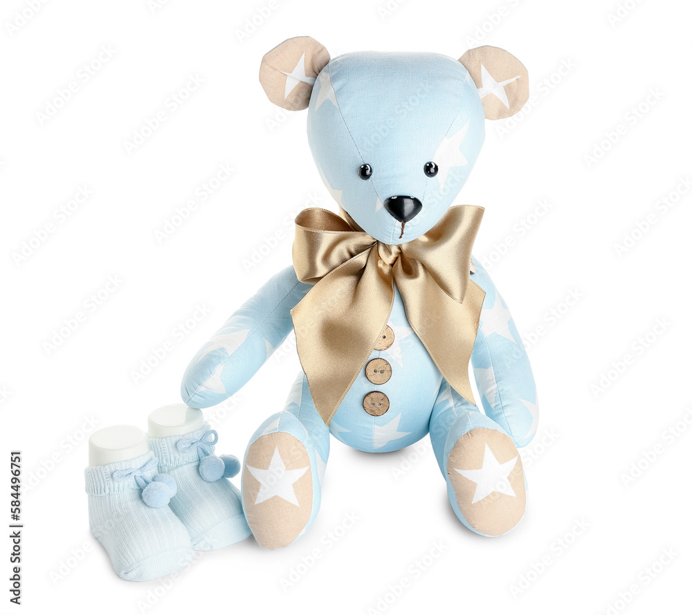 Toy bear with baby socks on white background